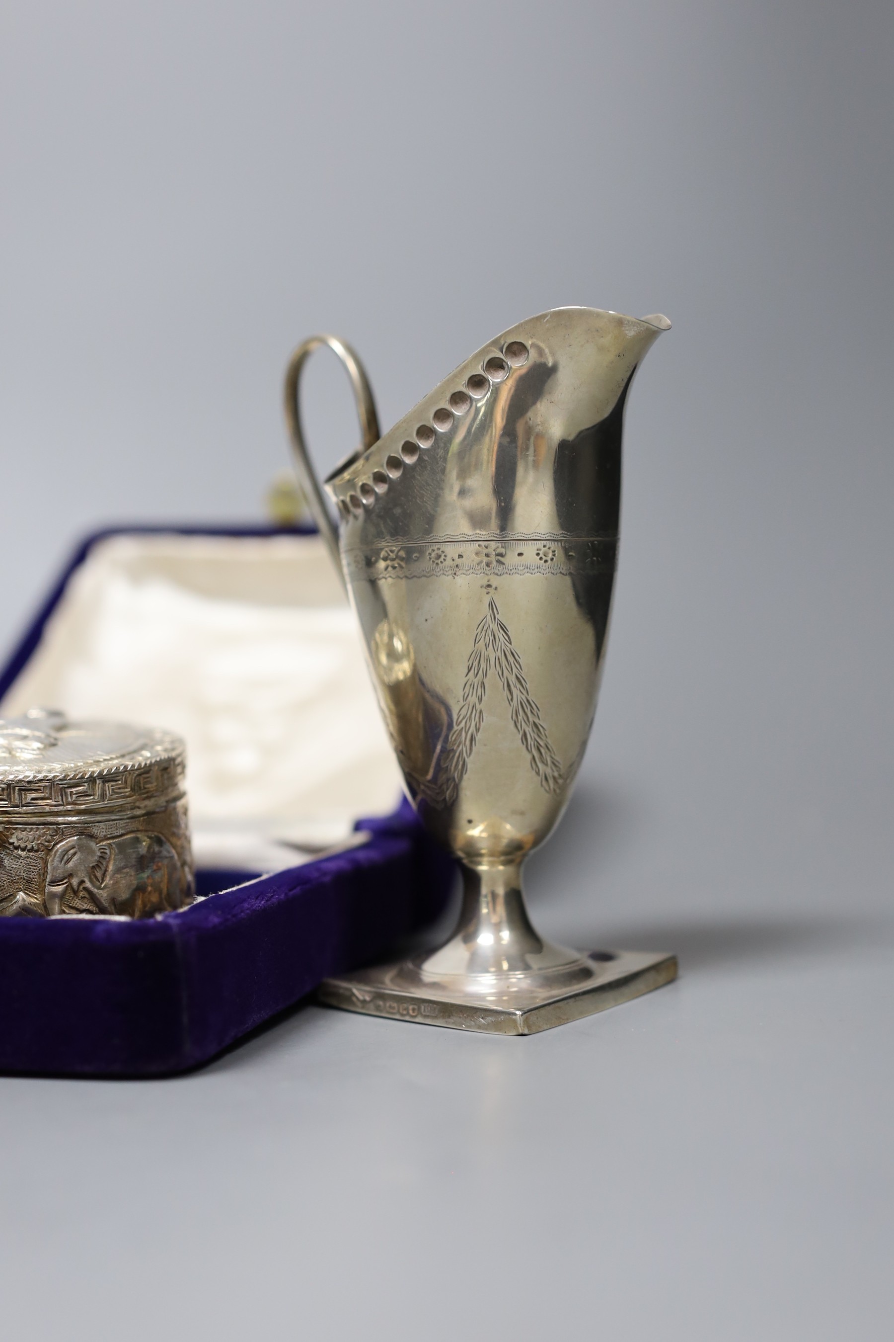 A Victorian engraved silver cream jug, Sheffield 1882, 13cm., engine-turned silver cigarette case, collection of pepper grinders, condiments, etc.